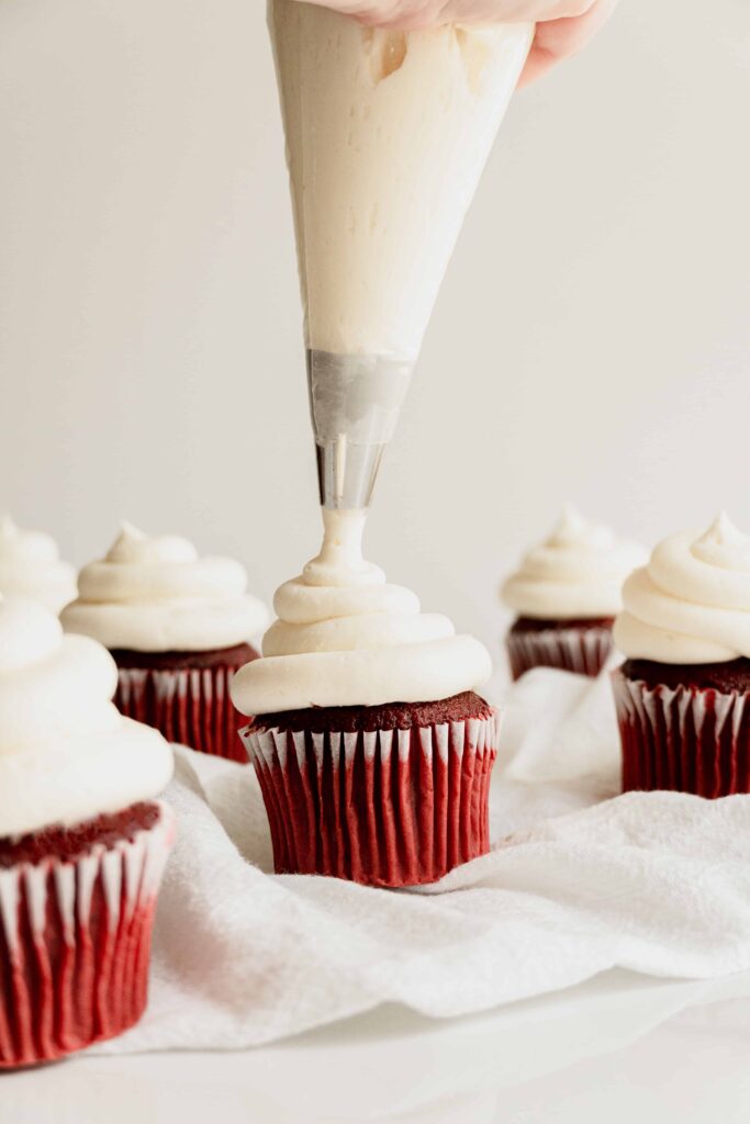 piping-cupcakes-with-the-best-vanilla-american-buttercream-frosting.