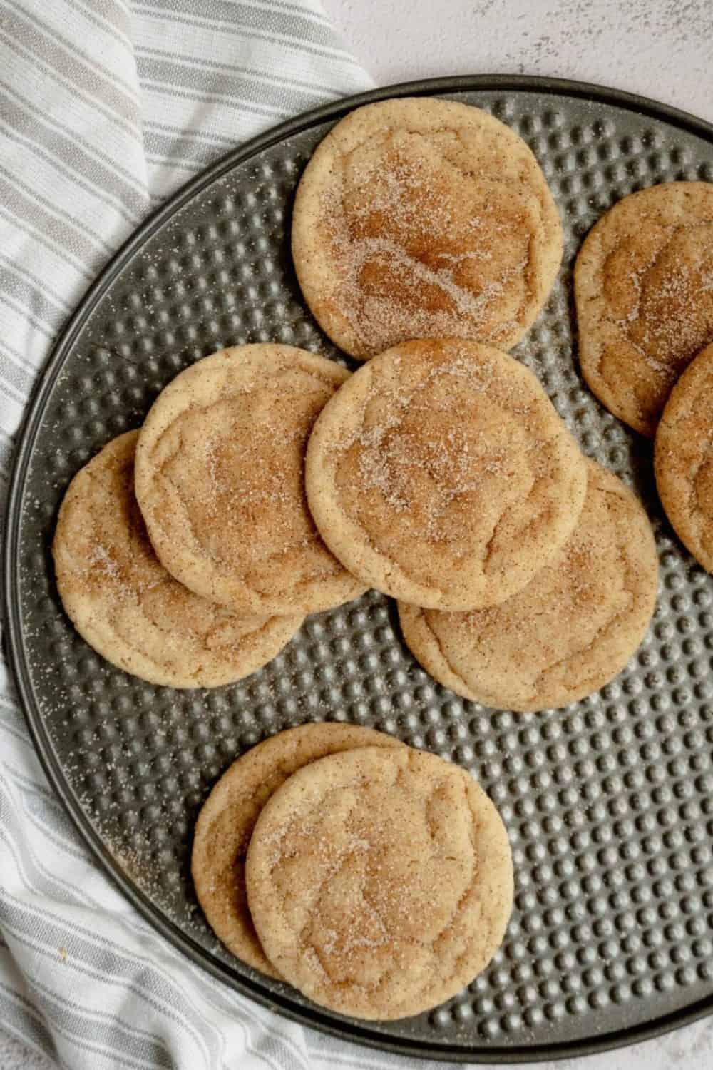 Snickerdoodle cookies on a round metal tray.