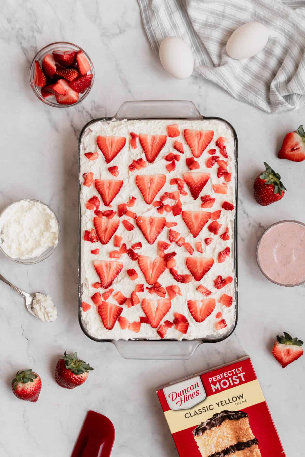 Cake with fresh strawberries on top.